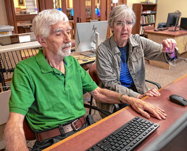 Hillary Schau, right, works with Rick Wallis to find relatives in Scotland. Schau, who will be teaching an Intro to Genealogy series at the Sunderland Public Library, is a member of the Association of Professional Genealogists and has been researching her family tree since the 1980s.