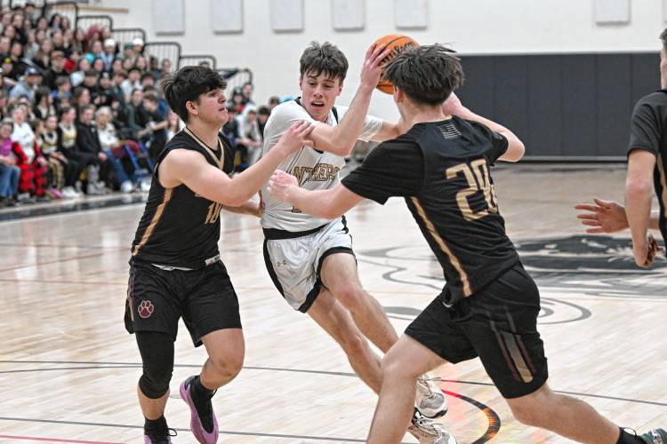 Pioneer’s Brayden Thayer splits two Old Colony defenders during the top-seeded Panthers’ victory in the MIAA Division 5 Round of 16 on Tuesday at Messer Gymnasium in Northfield. 