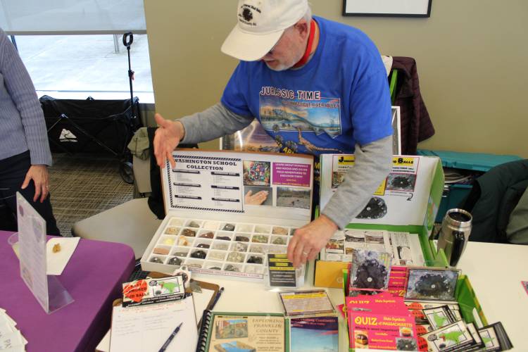Richard Little, of Save the Jurassic Armored Mud Balls, displays a case of rocks and minerals at Greenfield Community College’s Involvement Expo Wednesday evening. The event was designed to showcase opportunities for residents to join social and civic associations, nonprofits, sports and hobby clubs, mutual aid and other community-building groups.