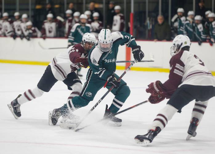 Greenfield’s Jake Jurek (2) maneuvers the puck between the Amherst defense earlier this season at Orr Rink in Amherst.