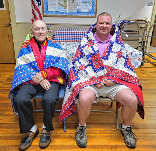 Military veterans Alfred O. “Ollie” Ohlson, left, and Dereck G. Dowler received Quilts of Valor at a ceremony at the North Orange Grange on May 14.