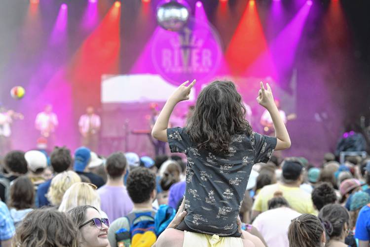 A young audience member shows his appreciations for sibling act Lawrence playing the main stage on Friday night at the Green River Festival at the Franklin County Fairgrounds.