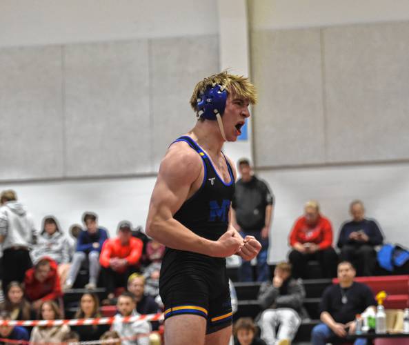 Mohawk Trail's Logan Moore celebrates after winning the 157 pound weight class during the MIAA Div. 3 West Championship at Mount Greylock High School Saturday. 