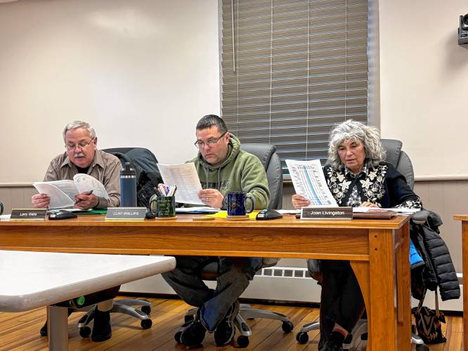 From left, Buckland Selectboard members Larry Wells, Clint Phillips and Joan Livingston review a draft of the fiscal year 2026 budget. From left, Buckland Selectboard members Larry Wells, Clint Phillips and Joan Livingston review a draft of the fiscal year 2026 budget.