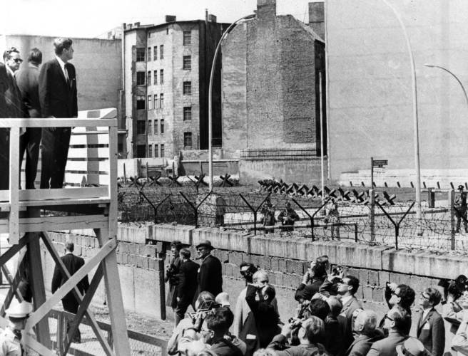 U.S. President John F. Kennedy stands on an observation platform near Checkpoint Charlie to look over the Berlin Wall toward East Berlinon June 26, 1963. U.S. President John F. Kennedy stands on an observation platform near Checkpoint Charlie to look over the Berlin Wall toward East Berlinon June 26, 1963.