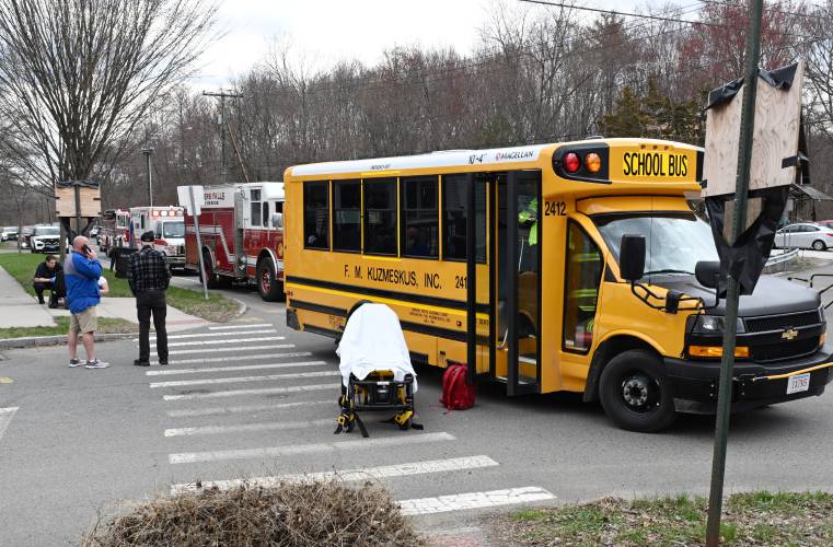 Emergency personnel evaluate passengers on a small school bus involved in a collision on Montague City Road and Depot Street in Montague City. 