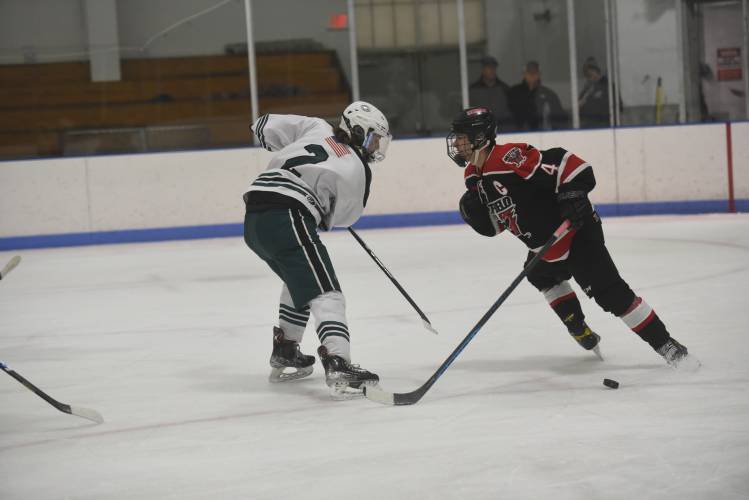 Greenfield's Jake Jurek tries to make a move around Westfield defenseman Mike Pelletier on Wednesday at Collins-Moylan Arena.  