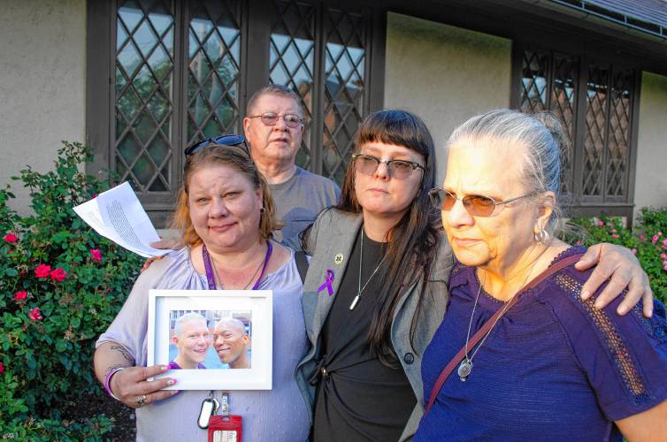 Sarah Ahern and Rebecca Josie with their parents, Andrea Goldman Butynski and Donald Butynski. Josie holds a photo of her late brother, left, with his late husband, who were both lost to overdose.