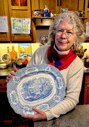 Becky Baxter Clark with her great-grandmother Rebecca’s platter, which she believes was purchased during a honeymoon trip to England and Argentina.