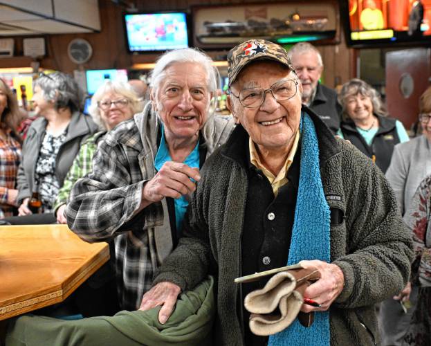 Lee Evers, right, who turned 102 on Feb. 12, at his birthday party at St. Kazimierz Society in Turners Falls with his son, David Gladstone, on Thursday.