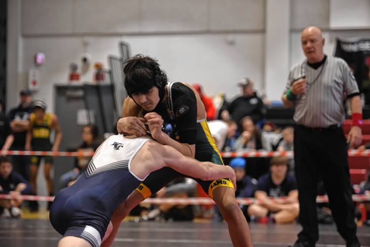 Franklin Tech's Carsten Couture goes for the takedown against Duggan's Jeremiah Patrick in the championship match at 120 during the MIAA Div. 3 West Championship at Mount Greylock High School Saturday. 