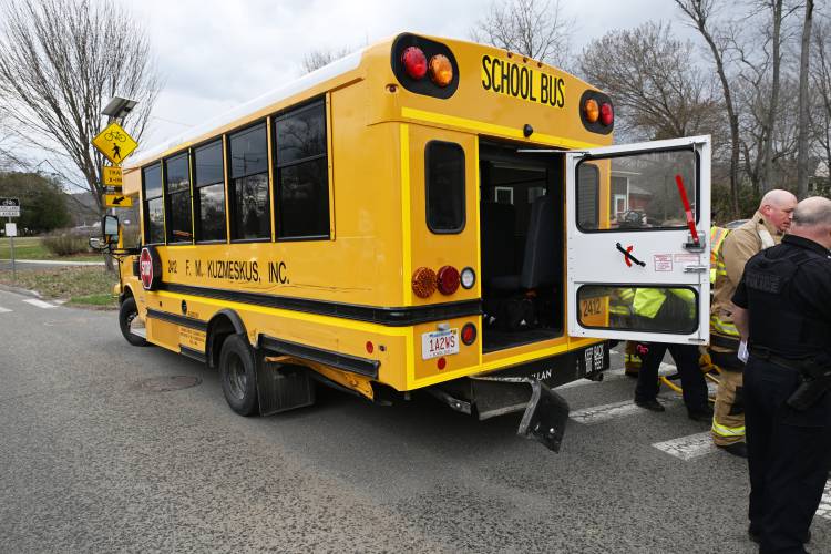 Emergency personnel evaluate passengers on a small school bus involved in a collision on Montague City Road and Depot Street in Montague City. 
