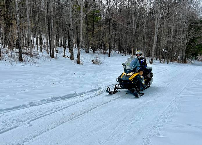 Steven Howland, president of the Buckland Riders Snow Mobile Club, riding on the snowmobile trail system near his home. Snowmobiles can go up to 60 mph, but they typically drive 20 to 30 mph on trails.
