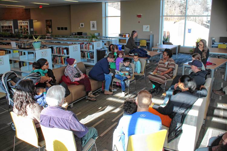 Michael, 7, and Kim Zabek read a children’s book on Martin Luther King Jr.’s life during a story hour at Greenfield Community College’s 25th annual Martin Luther King Jr. Day celebration.