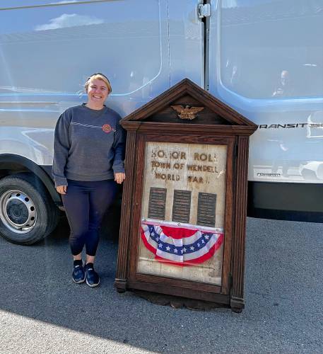 Rebecca Hohmann, who lives on Moffett Federal Airfield in Mountain View, California, where her wife serves in the U.S. Air Force as a helicopter mechanic, poses with a World War II memorial she recently sold to Hollister, California, resident Jim Gillio. Gillio intends to have the memorial restored and returned to its rightful home in Wendell, Massachusetts.