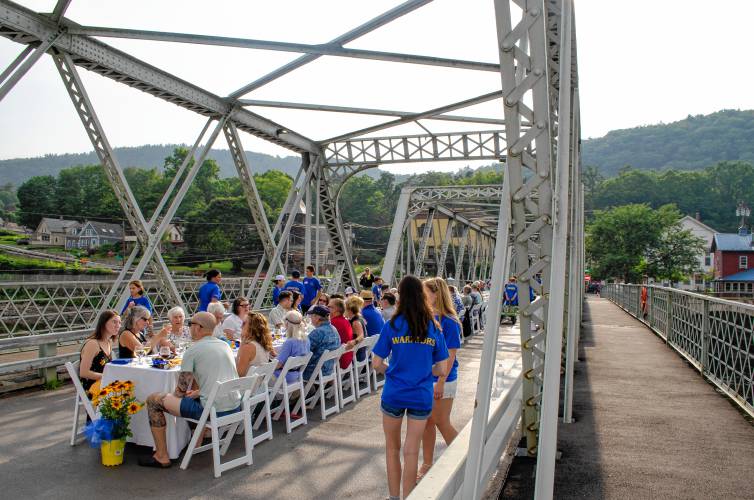 Community members enjoyed dinner on the scenic Iron Bridge in Shelburne Falls on Sunday, all while raising money for local athletic programming.