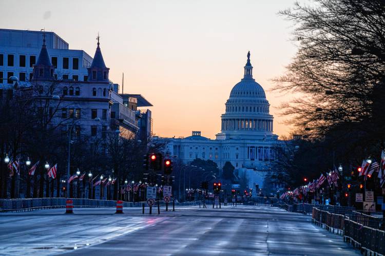 The sun rises behind the U.S. Capitol Building, seen from Pennsylvania Avenue. The sun rises behind the U.S. Capitol Building, seen from Pennsylvania Avenue.