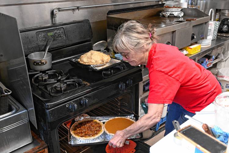 Helen Baker puts holiday pies in the oven at Baker’s Country Store in Conway. 