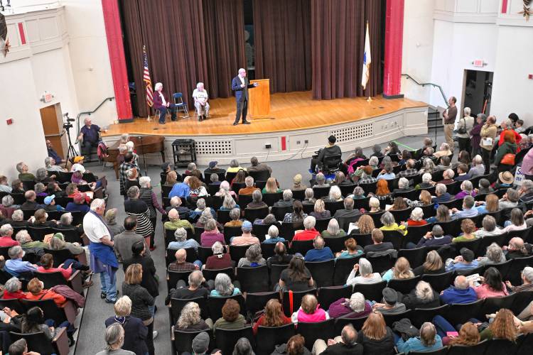 People line up in the aisles to speak to and ask questions of U.S. Rep. Jim McGovern at a town hall event at Greenfield Middle School Tuesday evening. 