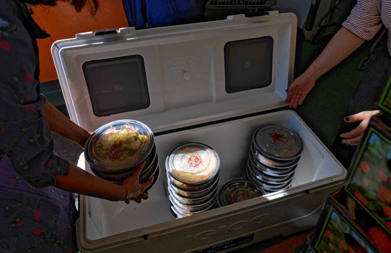A cooler full of pre-made burritos are unloaded at the Northampton Survival Center. The Survival Center is partnering with local restaurants La Veracruzana and Uya Poke Bowl to provide more than 2,800 meals.
