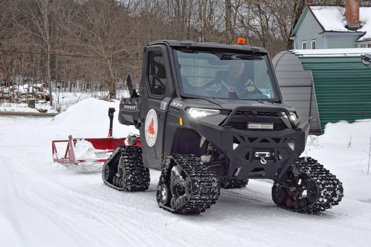 Steven Howland, president of the Buckland Riders Snow Mobile Club in the Buckland Rider's trail grooming machine.