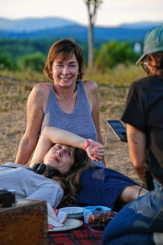 Julianne Nicholson and Annie Baker, her head in Nicholson’s lap, take a break on the set during filming of “Janet Planet,” the debut film by Baker, the celebrated playwright.
