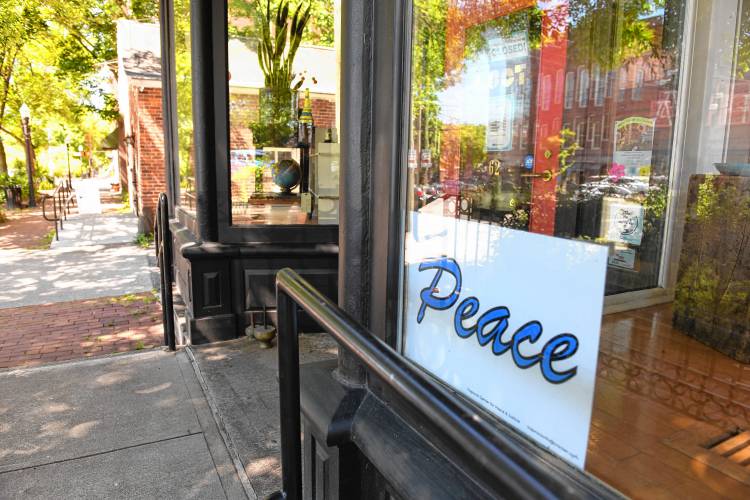 A peace sign in the window at LOOT found + made in Turners Falls.