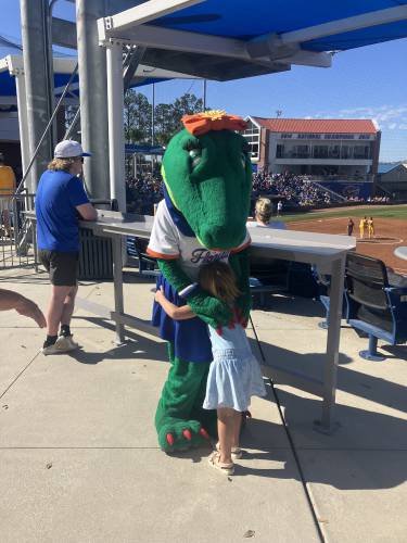 A fan with the Florida Gator mascot at a game this spring. 