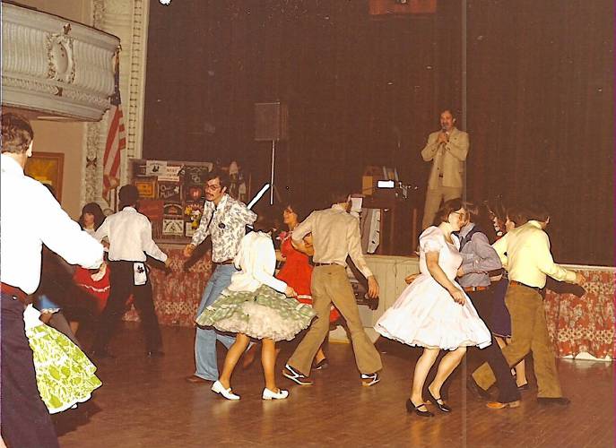 The Jumptown Twirlers, pictured here in living color circa the late 1970s, swing their partners around the Orange Town Hall dance floor.