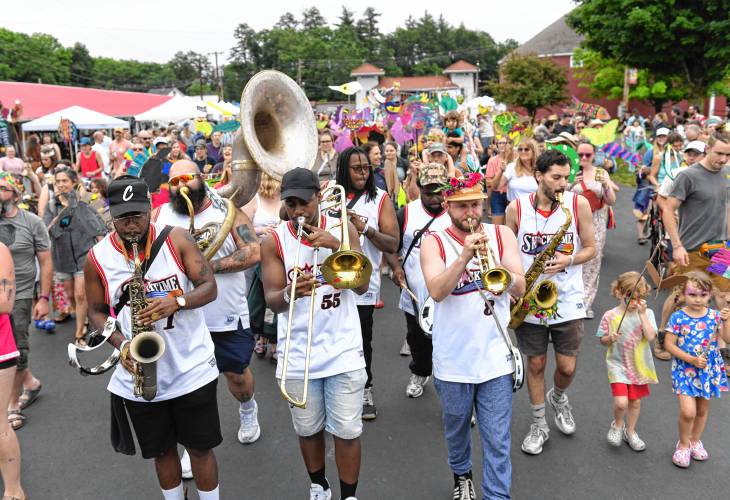 The band Snacktime leads the Art Garden parade through the crowd on Saturday at the Green River Festival at the Franklin County Fairgrounds.