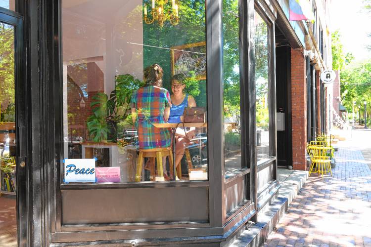 A peace sign in the window at The Upper Bend in Turners Falls. 