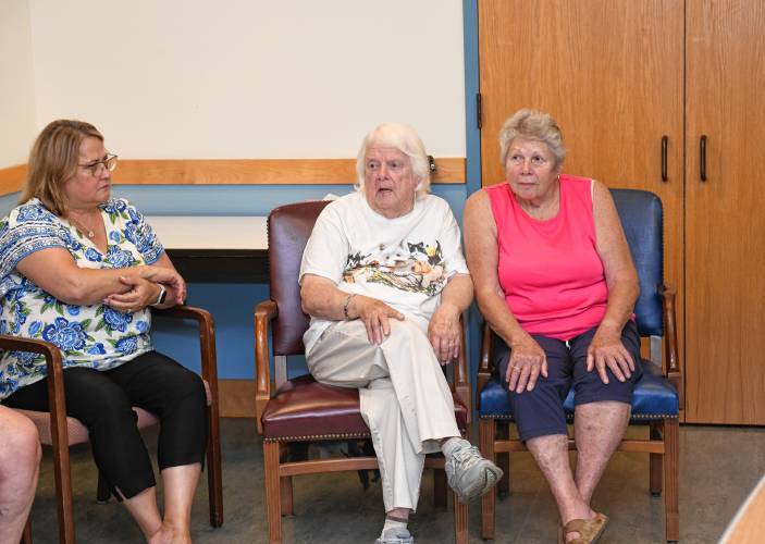 Wendell resident Del Williston, center, talks about her relatives who are listed on the refurbished World War II memorial in the Wendell Town Offices. The memorial was recently returned to Wendell and unveiled Wednesday.