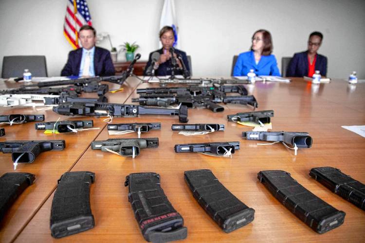 Ghost guns and ghost gun parts are displayed on a table in Attorney General Andrea Campbell’s office at a press event she hosted on July 11, 2023.