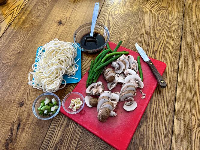 What one adds to the noodles is up to the cook. Some people add very little, just flavoring vegetables like scallions or Chinese chives. James-Beard-Award-winning chef Chung Sun Lau makes a delectable-sounding lobster version. I decided to keep my noodles simple, with some green beans for color and crunch, and sliced mushrooms for nutrition.