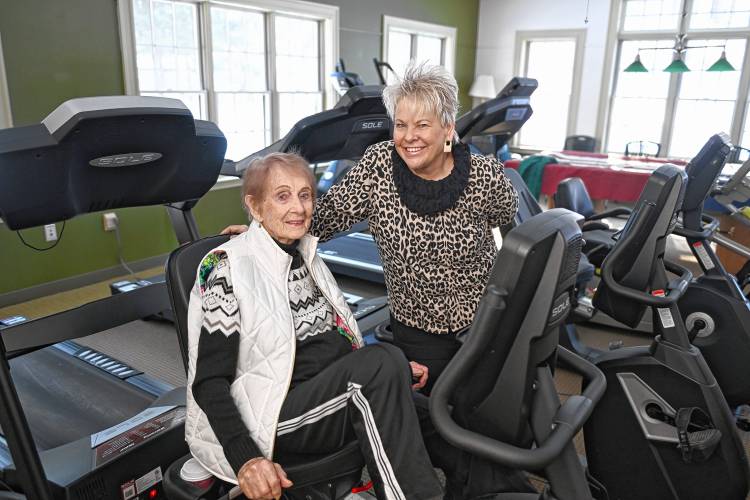 Erving Senior & Community Center Director Paula Betters, right, with 96-year-old Janis Lefebre in the exercise room.