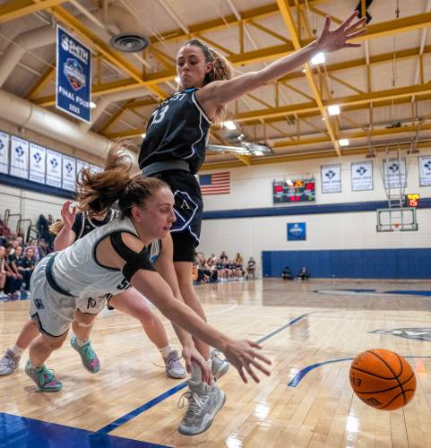 Smith guard Ally Landau, left, passes the ball around Amherst guard Laura Mendell, right, during the NCAA Division 3 Women's Basketball tournament Round of 32 game at Ainsworth Gym, Saturday, March 8, 2025, in Northampton.