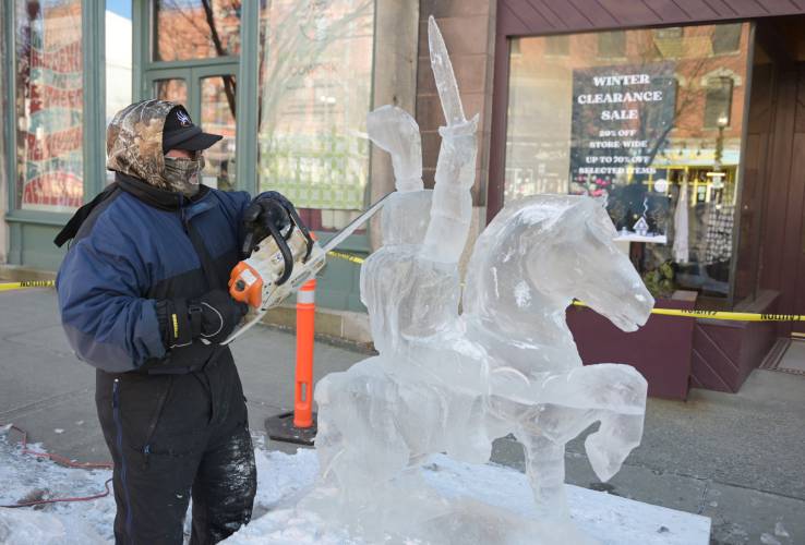 Athol resident Mark Bosworth carves his ice sculpture on Main Street in Greenfield for the 2023 Winter Carnival. The 102nd annual event returns Friday through Sunday.