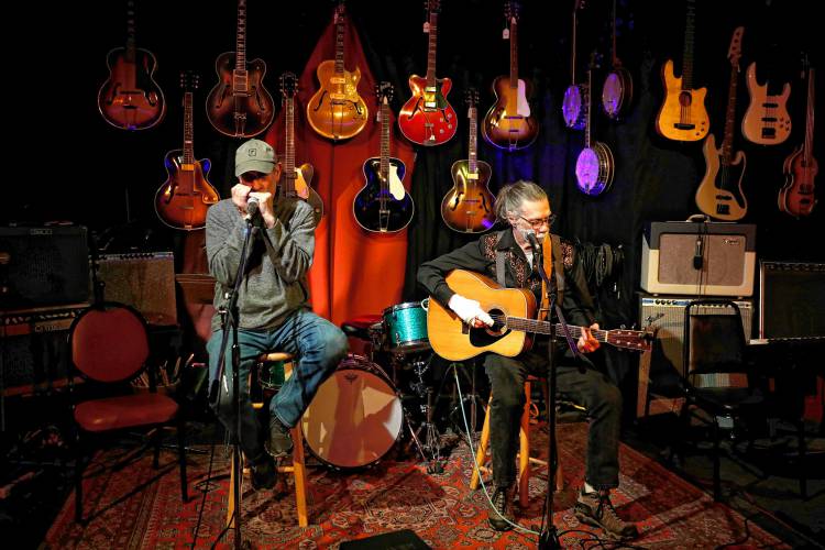 Peter Curro, left, and Bob Demers play a version of Bob Dylan’s “You Ain’t Goin’ Nowhere” at a recent open mic at Luthier's Co-op in Easthampton. Demers, known as Bobby D., also helps host open mics at Luthier’s.