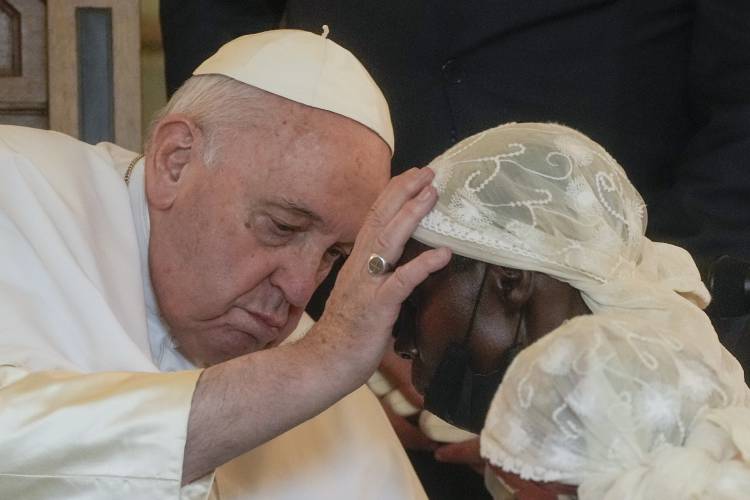 Pope Francis caresses a victim of violence in eastern Congo, at the Apostolic Nunciature in Kinshasa, Democratic Republic of Congo on Feb. 1, 2023.