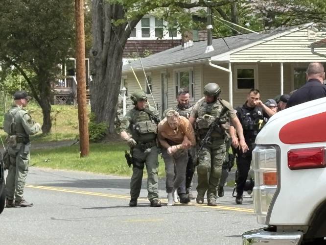 Franklin County Regional Special Response Team officers apprehend William Judd, 57, of Greenfield, after he allegedly barricaded himself in an Elm Street home with a firearm for six hours Friday.