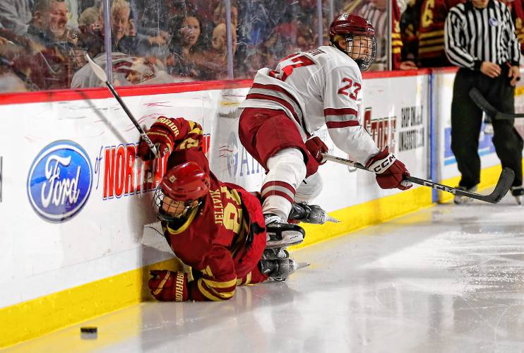 UMass defender Scott Morrow (23) knocks Boston College’s Oskar Jellvik (21) into the boards in the second period Friday night at the Mullins Center. UMass defender Scott Morrow (23) knocks Boston College’s Oskar Jellvik (21) into the boards in the second period Friday night at the Mullins Center.