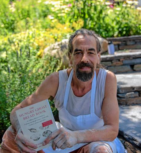 Jonathan Stevens with his “Hungry Ghost Bread Book” at the bakery in Northampton.