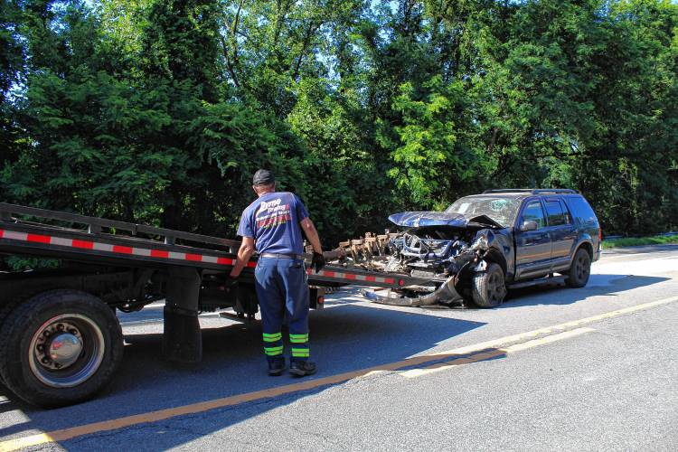 Byrne Towing of Greenfield tows a Ford Explorer from Route 10 in Northfield after the driver rear-ended a tractor on Monday afternoon.