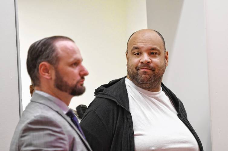 Taaniel Herberger-Brown, right, enters Greenfield District Court on Tuesday morning with his defense attorney Nicholas Horgan, at left, for his arraignment on a murder charge.