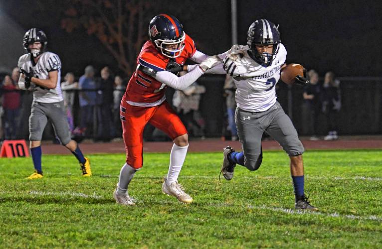 Frontier’s Carter Robinson chases down Franklin Tech’s Nolyn Stafford in South Deerfield Friday night. 