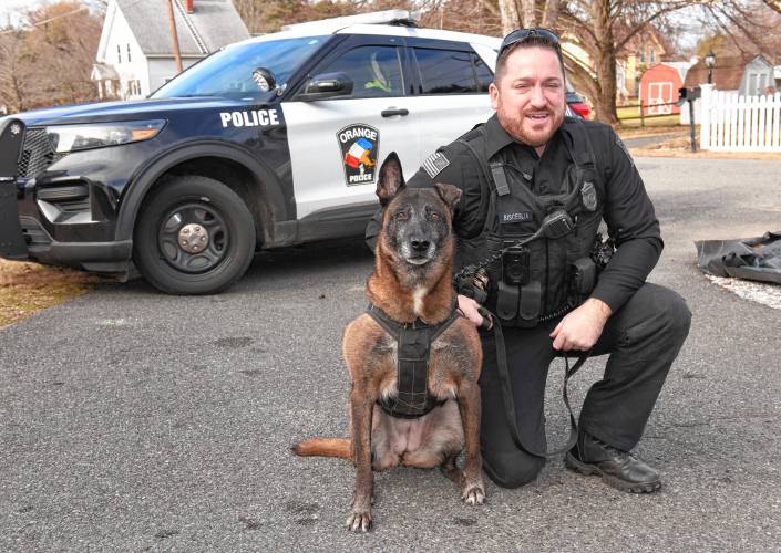 Orange Police Officer Christopher Bisceglia with retired K-9 Orka.