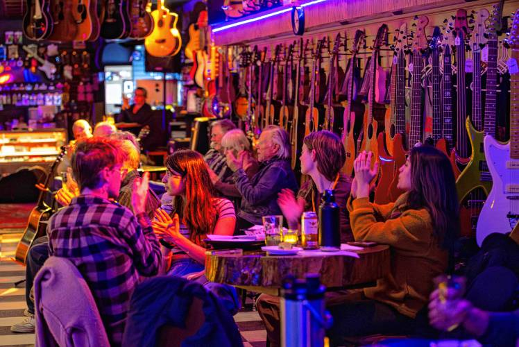 The crowd applauds after a performance during a Wednesday open mic night performance at Luthier's Co-op in Easthampton.