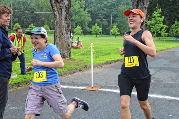 Mini mug race winners Hannah Goodwin and Rebecca Weiss crossing the finish line at the 43rd Montague Mug Race. 