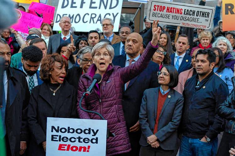 Sen. Elizabeth Warren, D-Mass., accompanied by other members of Congress, speaks during a rally against Elon Musk outside the Treasury Department in Washington, D.C. on Tuesday. Sen. Elizabeth Warren, D-Mass., accompanied by other members of Congress, speaks during a rally against Elon Musk outside the Treasury Department in Washington, D.C. on Tuesday.
