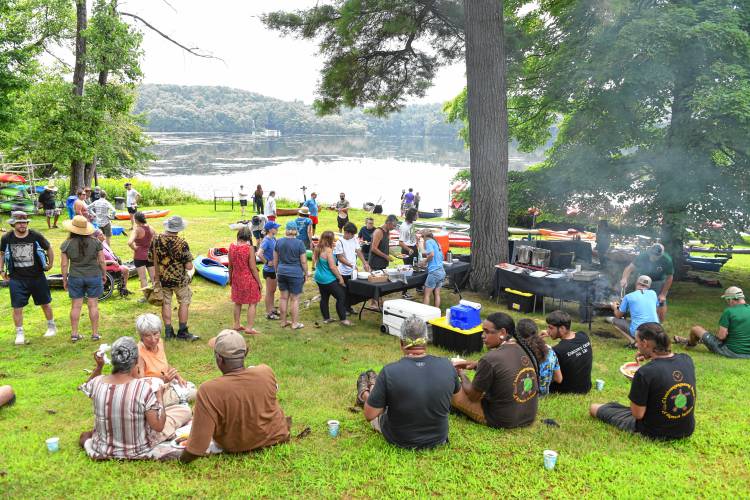 People enjoy lunch at Barton Cove before the Peskeompskut Paddle on Friday.